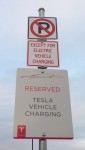signs saying No Parking except for electric vehicles, reserved for Tesla Vehicle Chargin