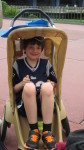 8 year old sitting in Disney stroller