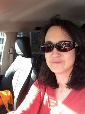Alicia wearing sunglasses in our new hybrid minivan